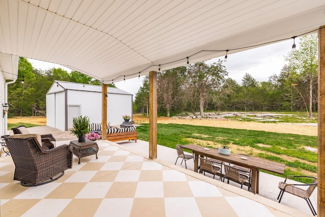 view of patio featuring an outbuilding, outdoor dining space, and a storage unit