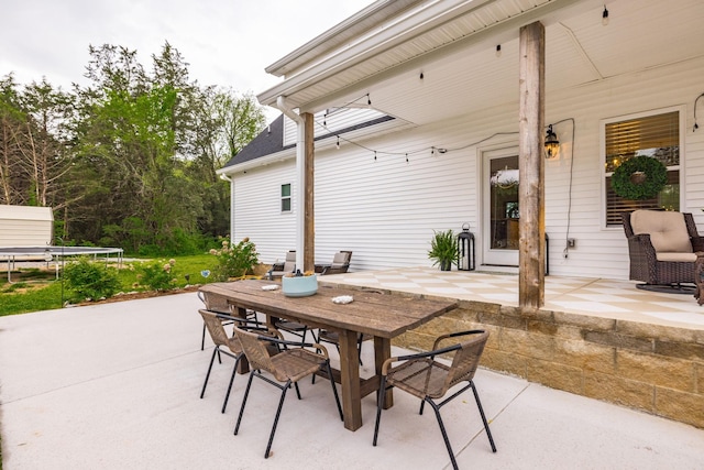 view of patio / terrace featuring outdoor dining space and a trampoline