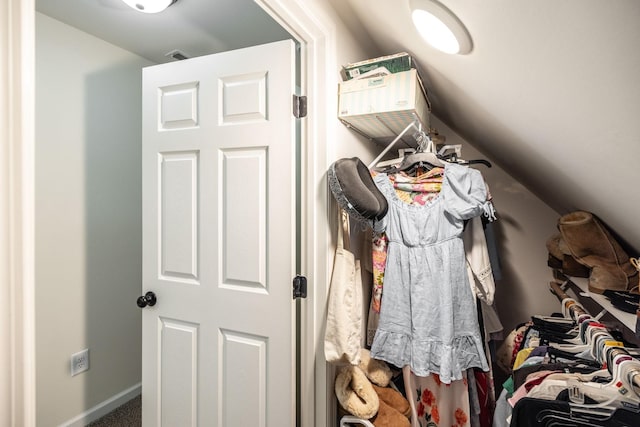 walk in closet with carpet