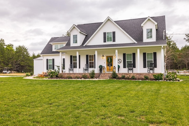 modern inspired farmhouse with board and batten siding, a porch, and a front yard