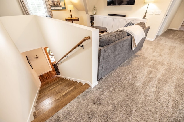 staircase with a wealth of natural light, baseboards, and carpet