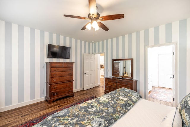 bedroom with baseboards, a ceiling fan, wood finished floors, and wallpapered walls