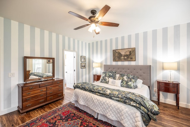 bedroom with baseboards, dark wood-style floors, and ceiling fan