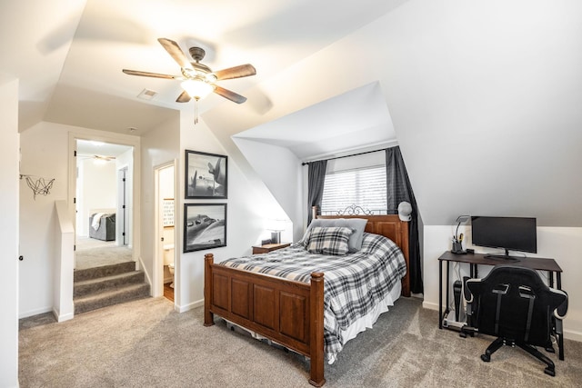 carpeted bedroom featuring baseboards, vaulted ceiling, visible vents, and ceiling fan