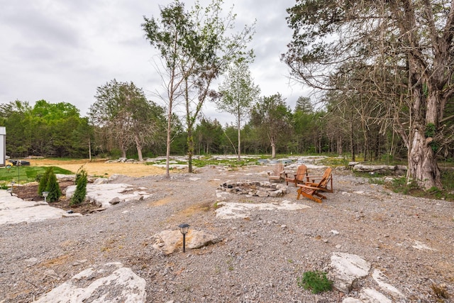view of yard with a view of trees