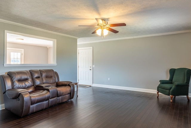 living room with a textured ceiling, ceiling fan, dark wood finished floors, baseboards, and ornamental molding