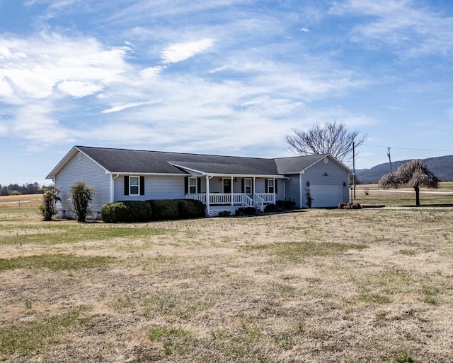 ranch-style house with a porch, a front lawn, and a garage