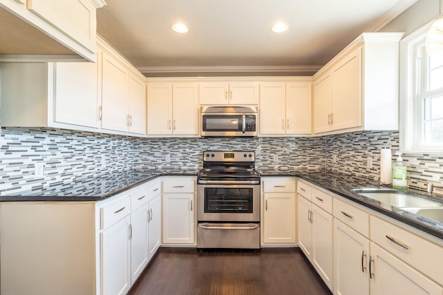 kitchen featuring white cabinets, recessed lighting, backsplash, appliances with stainless steel finishes, and dark wood-style flooring