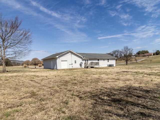 exterior space with a wooden deck, a yard, and a rural view