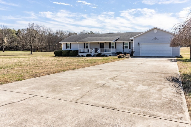 ranch-style home featuring a porch, an attached garage, driveway, and a front yard