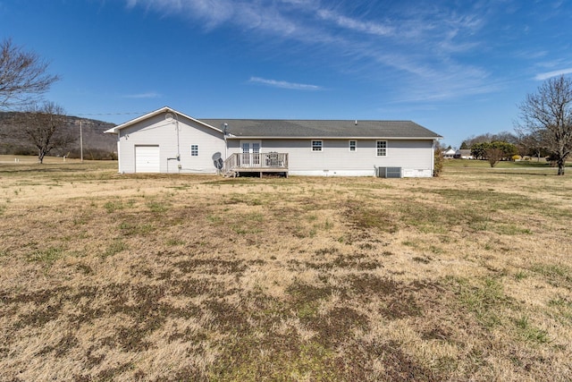 rear view of house with a yard and a deck