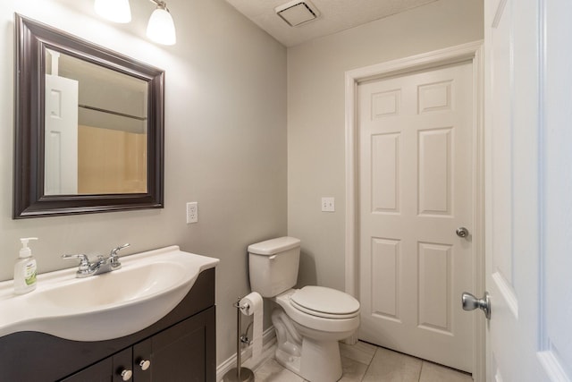 bathroom with tile patterned floors, a textured ceiling, toilet, baseboards, and vanity