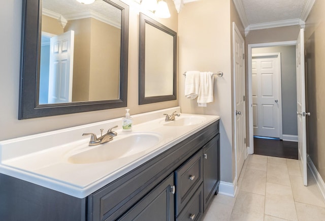 bathroom featuring double vanity, baseboards, and a sink