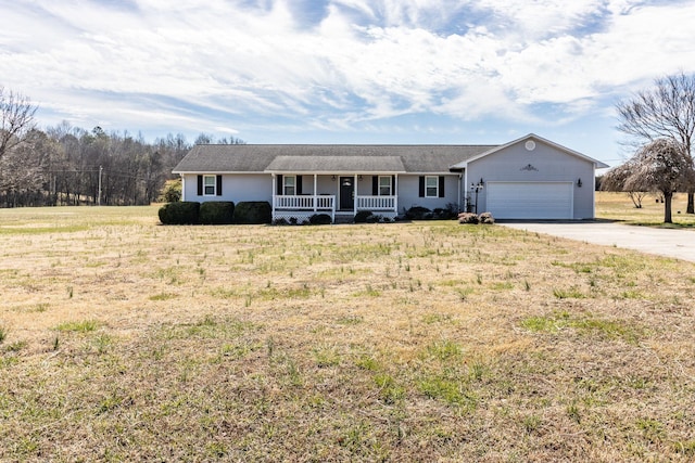 ranch-style house featuring a garage, covered porch, a front yard, and concrete driveway