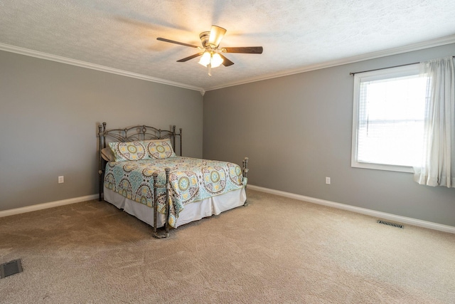 bedroom with baseboards, crown molding, carpet flooring, and visible vents
