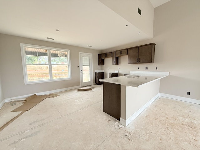 175 Cardinal Crk, Clarksville, TN 37040 - kitchen with baseboards, dark brown cabinetry, a peninsula, independent washer and dryer, and light countertops