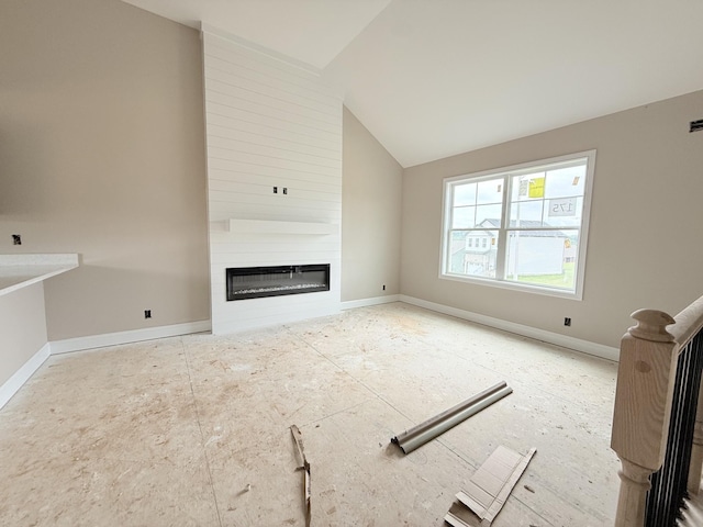 175 Cardinal Crk, Clarksville, TN 37040 - unfurnished living room featuring a fireplace, lofted ceiling, and baseboards
