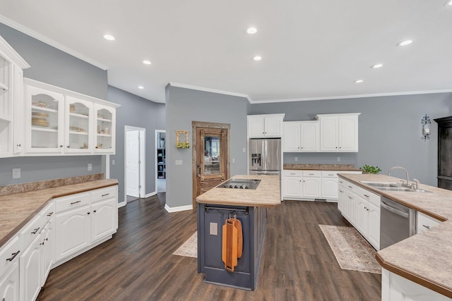 kitchen featuring a sink, crown molding, stainless steel appliances, and white cabinets