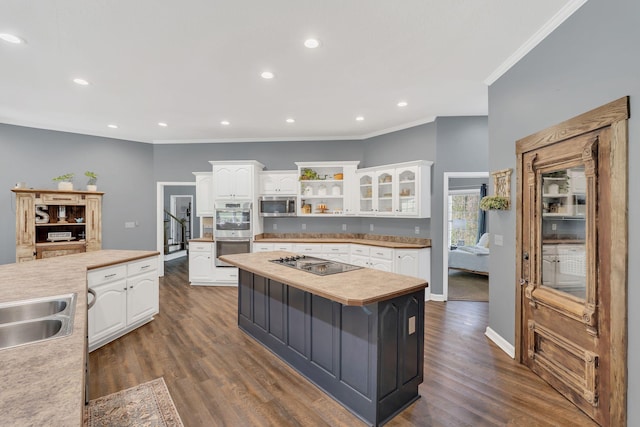 kitchen featuring crown molding, appliances with stainless steel finishes, and white cabinetry