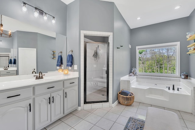 full bath with a notable chandelier, vanity, tile patterned floors, a shower stall, and a garden tub