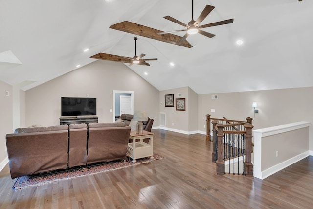 living room featuring visible vents, wood finished floors, baseboards, vaulted ceiling with beams, and a ceiling fan