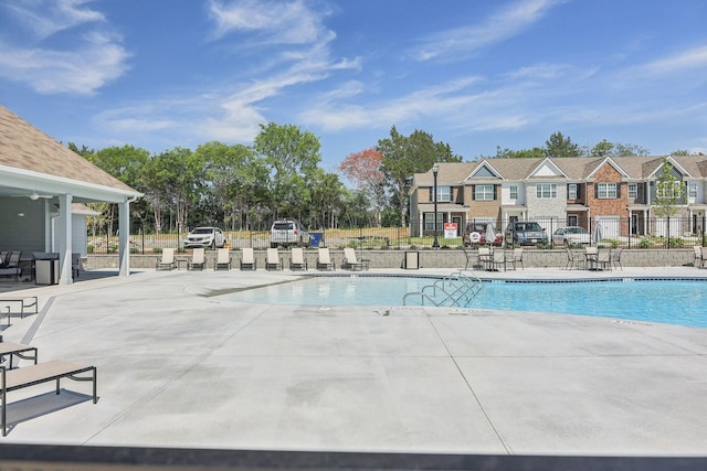 community pool featuring a patio area and fence