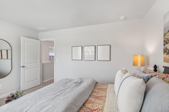 bedroom with carpet, visible vents, and baseboards