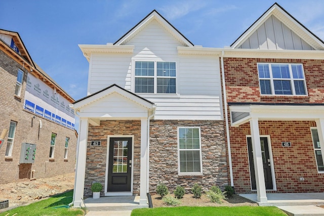 view of front of property with stone siding and board and batten siding
