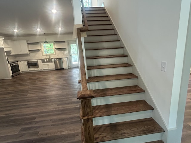 stairs featuring recessed lighting and wood finished floors