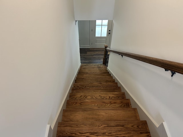 stairs featuring baseboards and wood finished floors