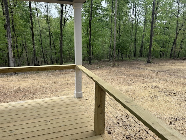 wooden deck featuring a forest view
