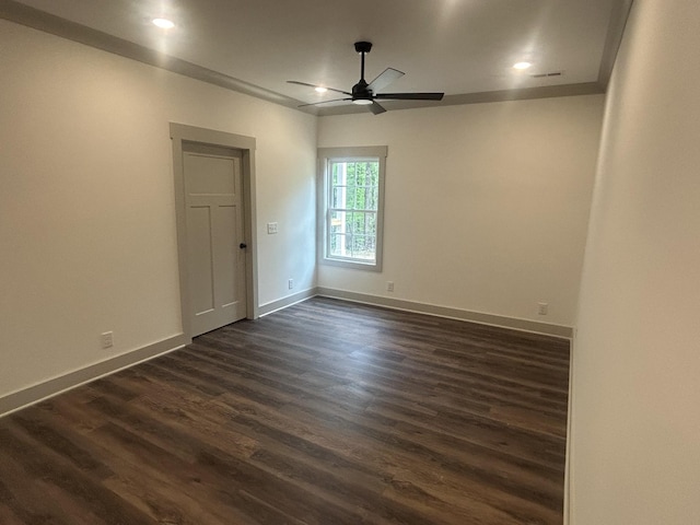 spare room featuring recessed lighting, ceiling fan, dark wood finished floors, and baseboards