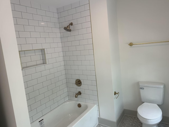 bathroom with toilet, baseboards, and shower / tub combination