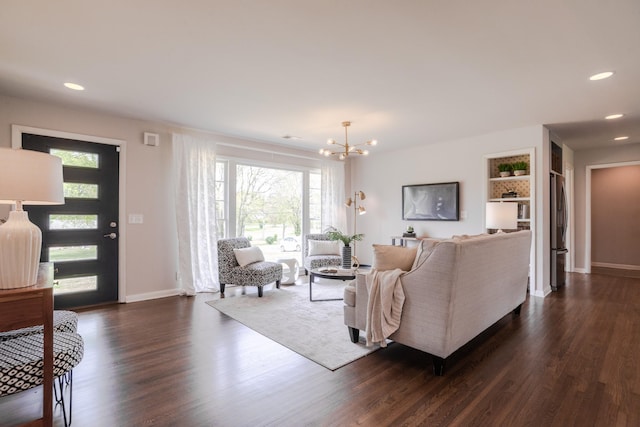 living area with baseboards, an inviting chandelier, dark wood-style flooring, and recessed lighting