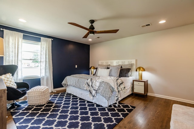 bedroom with a ceiling fan, wood finished floors, baseboards, visible vents, and recessed lighting