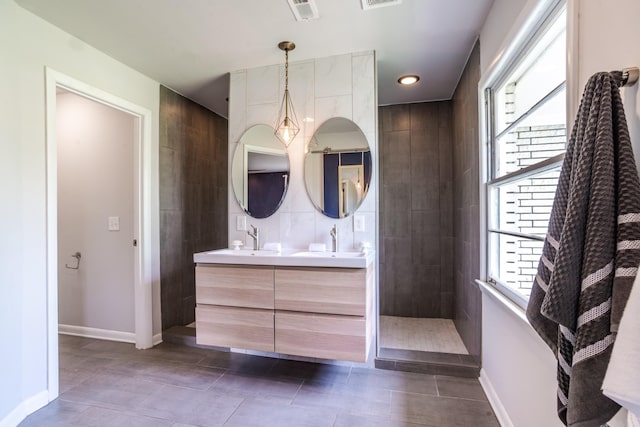 full bath with a wealth of natural light, walk in shower, and a sink
