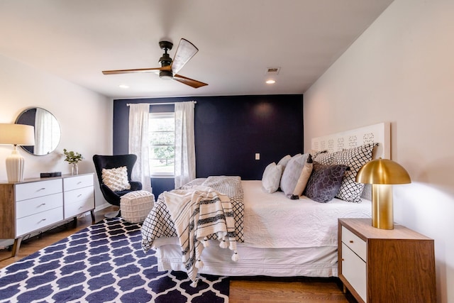 bedroom with recessed lighting, wood finished floors, and visible vents
