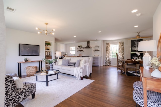 living area featuring baseboards, dark wood-type flooring, visible vents, and recessed lighting