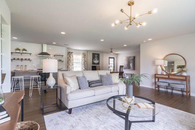 living area featuring recessed lighting, wood finished floors, and ceiling fan with notable chandelier