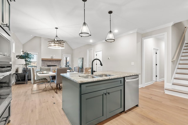 1111 Joe Martin Ln, Lebanon, TN 37087 - kitchen with light wood finished floors, stainless steel dishwasher, a sink, a stone fireplace, and decorative light fixtures