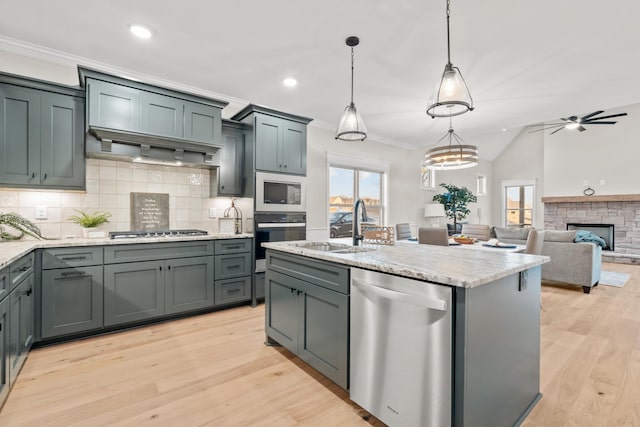 1111 Joe Martin Ln, Lebanon, TN 37087 - kitchen with stainless steel appliances, light wood-style floors, backsplash, crown molding, and light stone countertops
