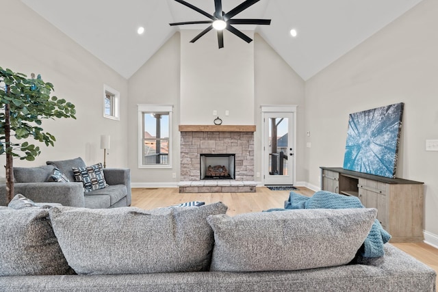 1111 Joe Martin Ln, Lebanon, TN 37087 - living room with baseboards, light wood-style floors, high vaulted ceiling, ceiling fan, and a fireplace