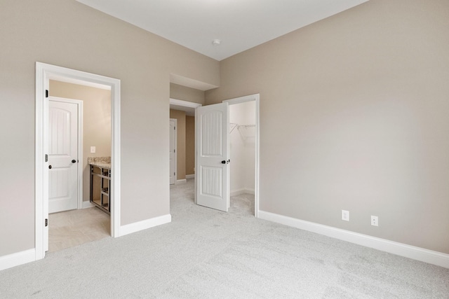 1111 Joe Martin Ln, Lebanon, TN 37087 - unfurnished bedroom with a spacious closet, light carpet, ensuite bath, a closet, and baseboards