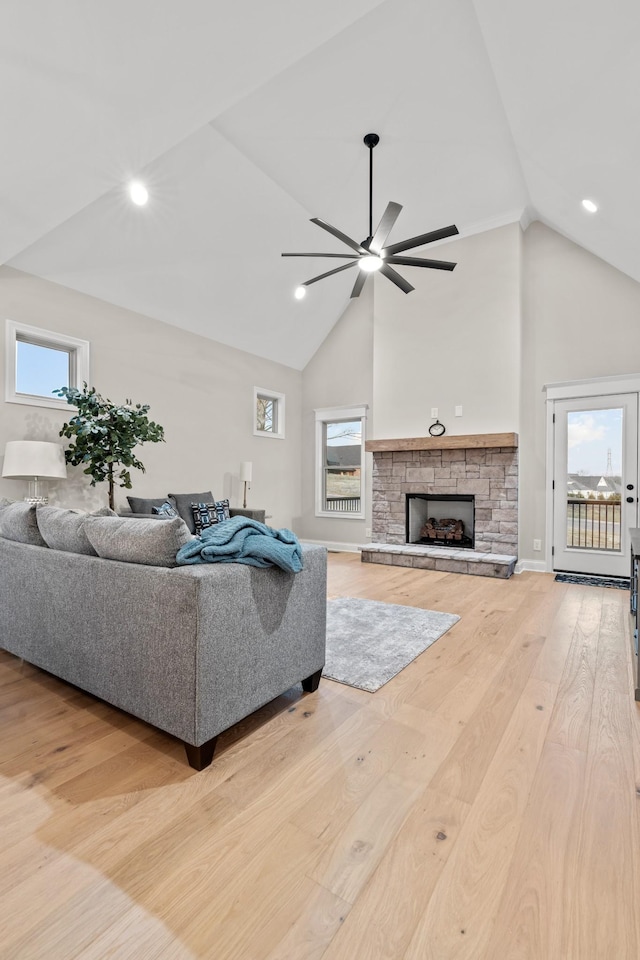 1111 Joe Martin Ln, Lebanon, TN 37087 - living area featuring recessed lighting, a ceiling fan, wood finished floors, a stone fireplace, and high vaulted ceiling