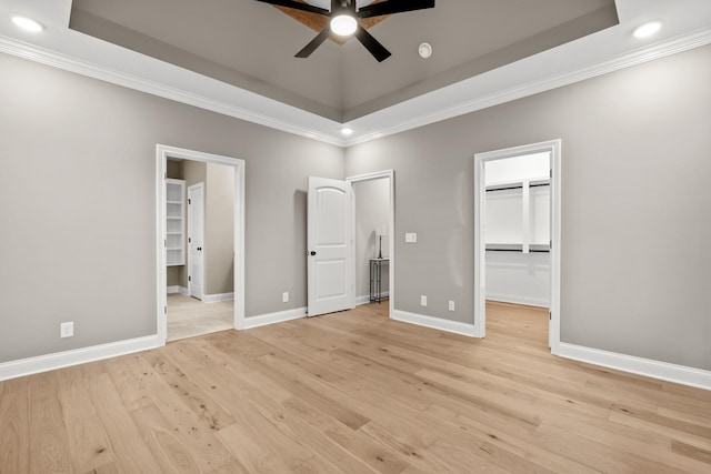 1111 Joe Martin Ln, Lebanon, TN 37087 - unfurnished bedroom with a tray ceiling, light wood-style floors, a spacious closet, and crown molding