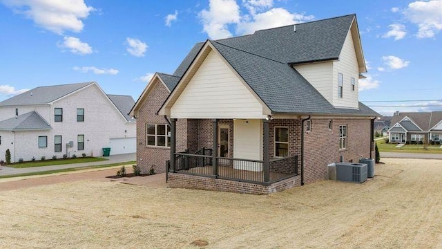 1111 Joe Martin Ln, Lebanon, TN 37087 - back of property with covered porch, brick siding, and central air condition unit
