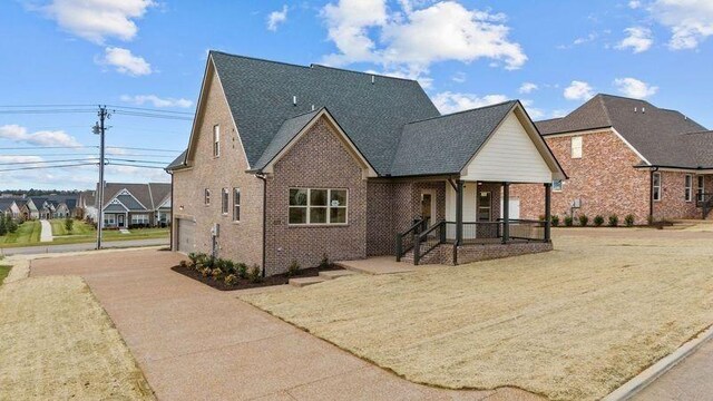 1111 Joe Martin Ln, Lebanon, TN 37087 - view of front facade with brick siding, driveway, and a garage