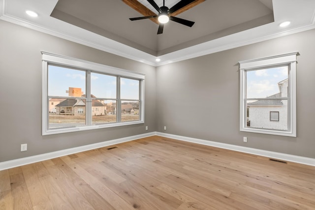 1111 Joe Martin Ln, Lebanon, TN 37087 - empty room featuring a ceiling fan, a tray ceiling, ornamental molding, and light wood-style flooring