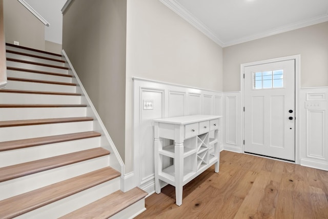 1111 Joe Martin Ln, Lebanon, TN 37087 - foyer entrance with a wainscoted wall, ornamental molding, light wood-style floors, a decorative wall, and stairs