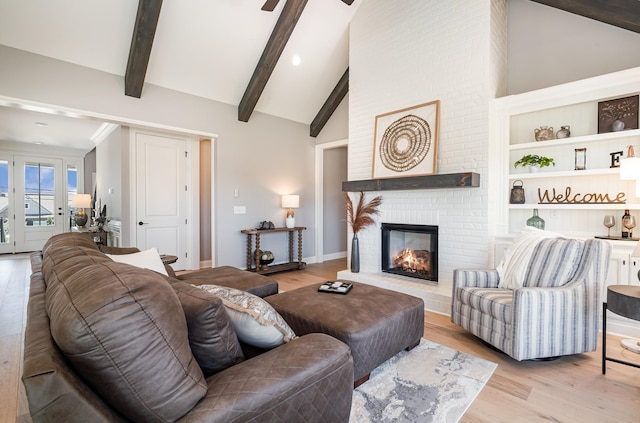 1117 Joe Martin Ln, Lebanon, TN 37087 - living room featuring high vaulted ceiling, wood finished floors, ceiling fan, a fireplace, and beam ceiling